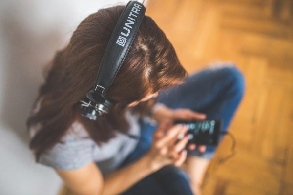 woman listening to music through headphones