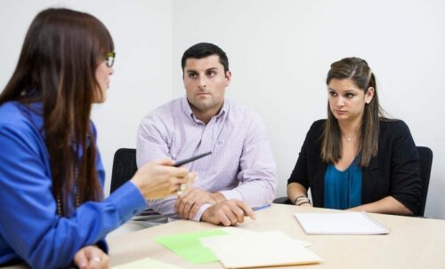 two women and a man in a meeting