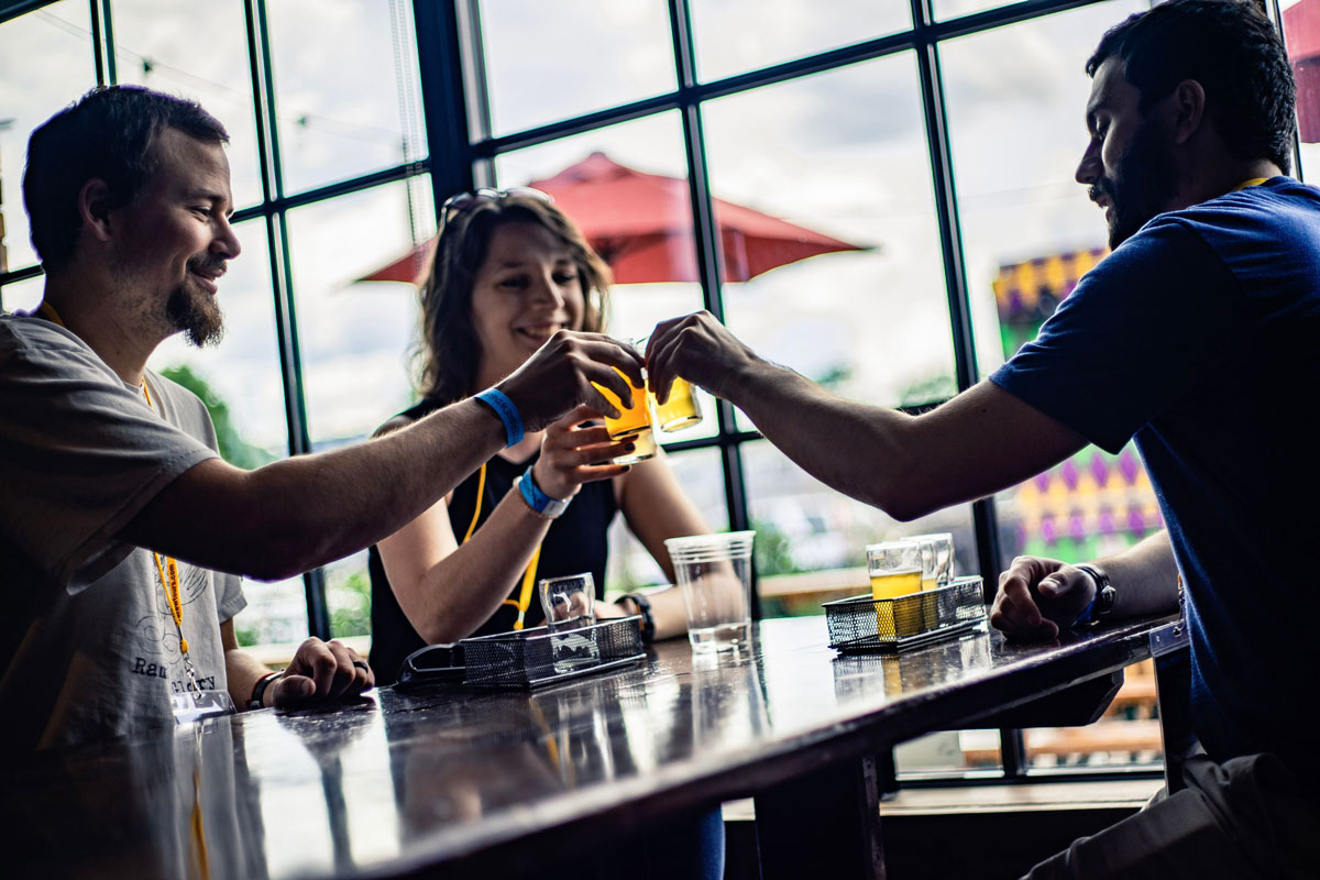 three-people-tasting-beer-and-cheersing